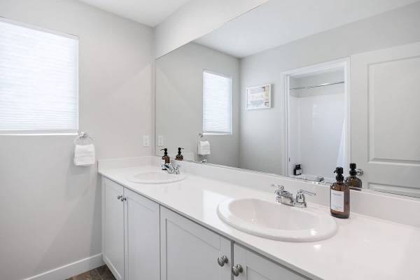 Clean lines and double vanities upstairs—guests enjoy hotel-quality comfort and convenience.
