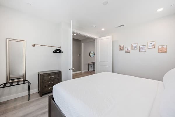 Bedroom features a hanging rod for your belongings.