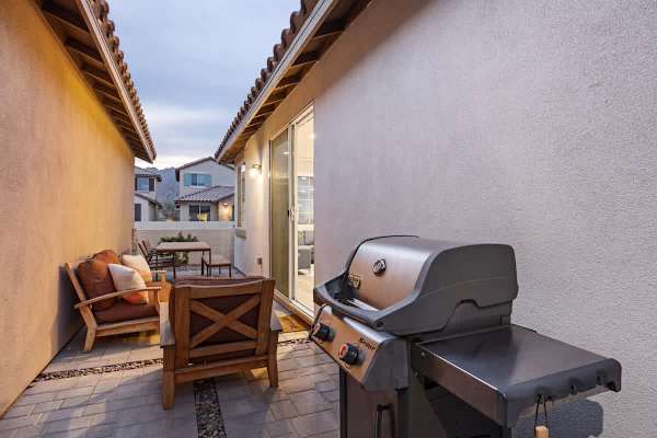 Enjoy outdoor dining and relaxation on the patio with seating and a BBQ.