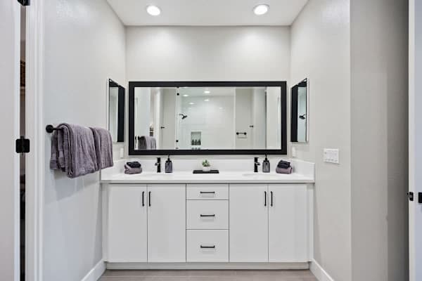 Spacious master bathroom featuring two vanity sinks.