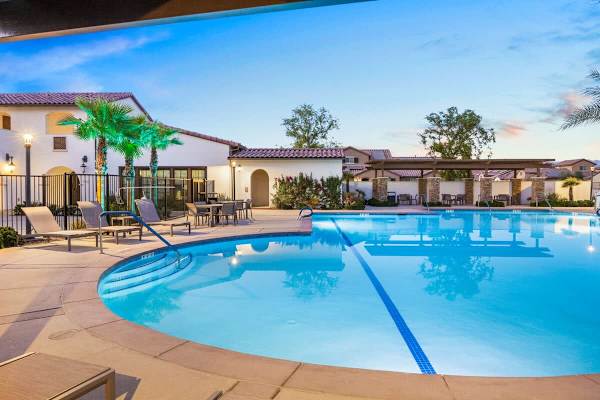 Community pool with a waterslide & plenty of chairs for everyone.