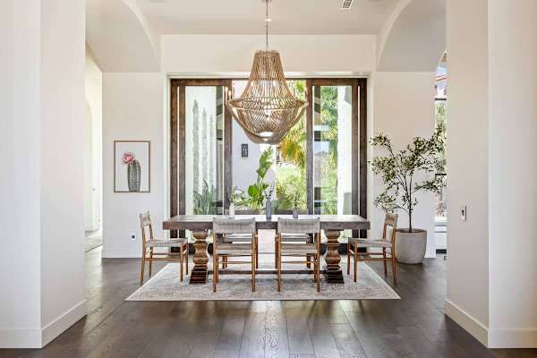 Elegant dining room with statement chandelier and seating for eight guests.