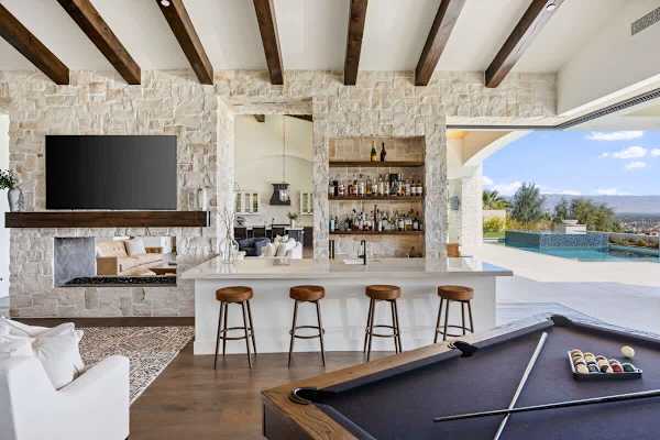 Entertain in style with a fully equipped outdoor kitchen and bar seating.