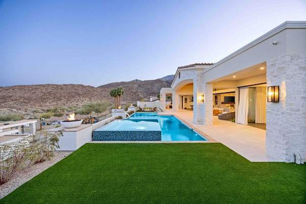 Lush artificial turf surrounds the infinity pool for easy outdoor living.