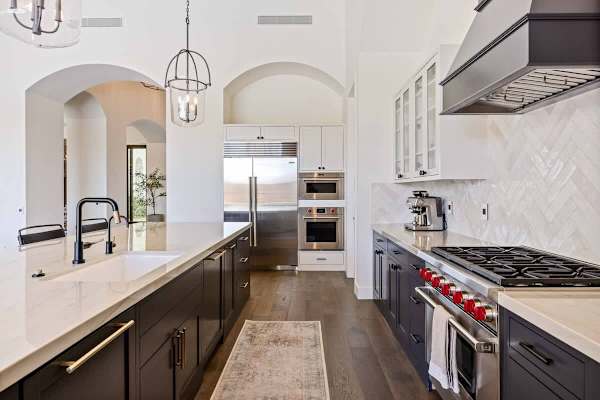 Chef's kitchen features a pro-grade gas range and spacious prep island.