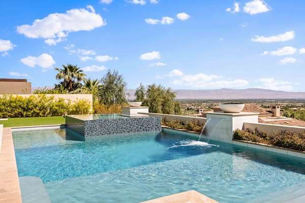 Infinity edge and cascading waterfall create a resort-style pool experience.