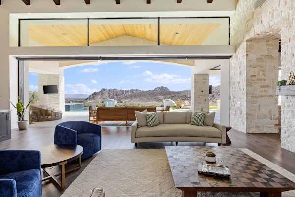Floor-to-ceiling windows frame the pool and mountains like living artwork.