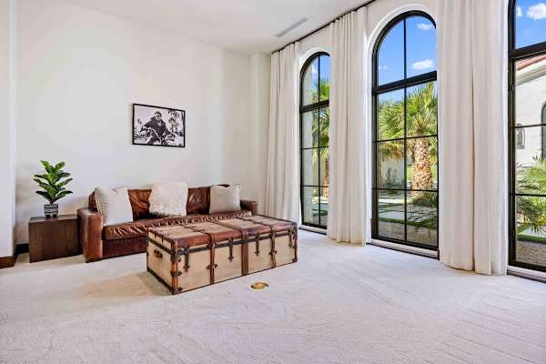 Flexible guest suite with a sitting area and stunning arched courtyard views.