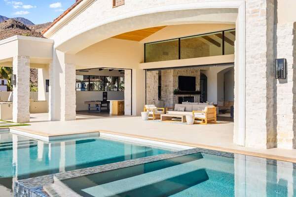 Shaded outdoor living with comfortable furniture and seamless indoor-outdoor flow.