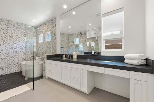 Indulge in luxury with a tub and walk-in shower in the master suite bathroom.
