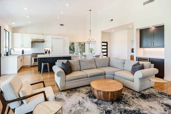 Open concept with sectional seating—bright space flows from living to kitchen.