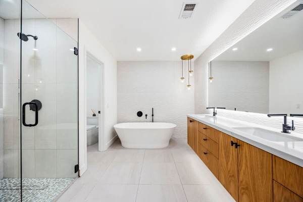 Primary bath with double vanities and natural light.
