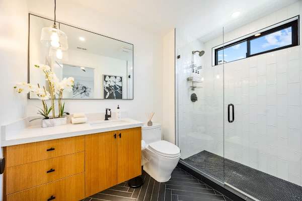 Suite 2 bath with wood vanity and walk-in shower.