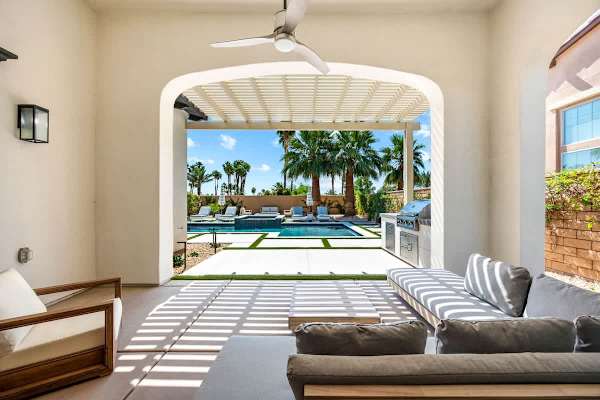 The covered patio space features a ceiling fan sure to keep you cool during sunny days.