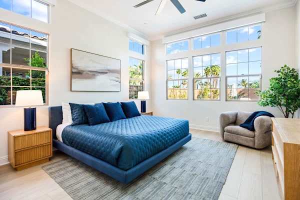 The master suite is spacious and features a king-sized bed.