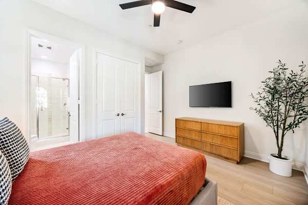 Suite 2 features a TV, and barn door closets that add character while saving space here.
