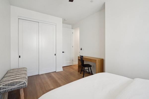 Bedroom two features a desk and a reach-in closet.