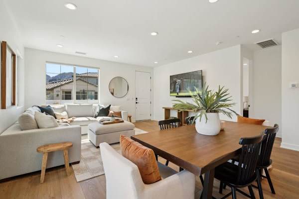 Dining table with comfortable seating and views into the living room keeps everyone connected during meals and games.