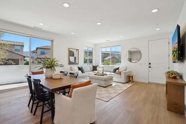 Dining table with seating for six and natural light from large windows makes every meal feel special and inviting.