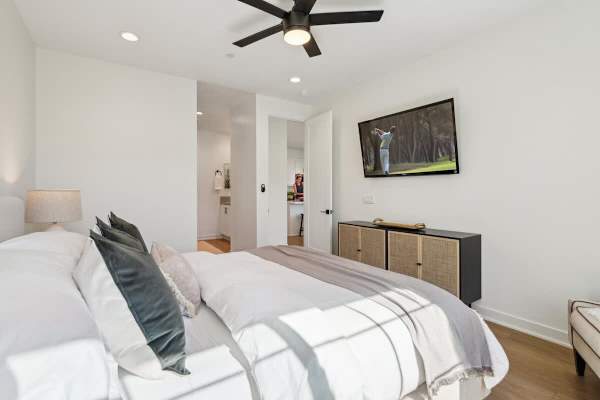 King bedroom with neutral tones and plenty of natural light offers a calm and comfortable space to rest nightly.