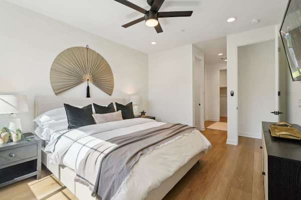 Primary bedroom with king bed and fan-style headboard creates a peaceful retreat after busy days exploring the desert.