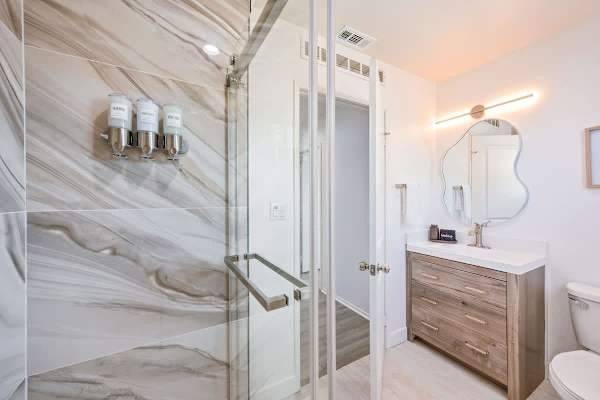 Guest bathroom with walk-in shower provides a spa-like experience.