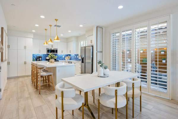 The dining table with the kitchen and living room all connected.
