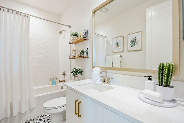 The hallway bathroom with tub-shower combo serves bedrooms two and three.