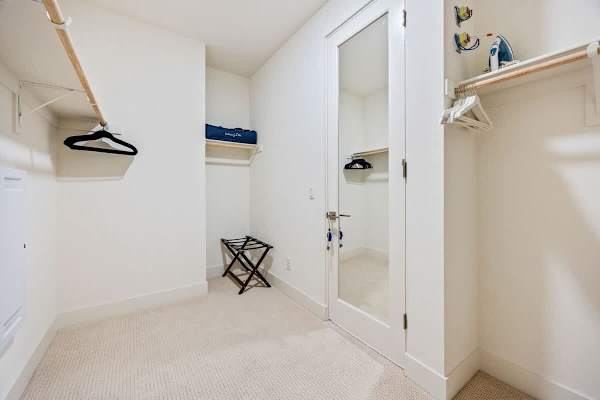 A spacious walk-in closet with built-in shelving for all your vacation wardrobe needs.