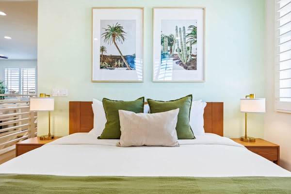 The third bedroom features a king bed with fresh green accents and desert vibes.