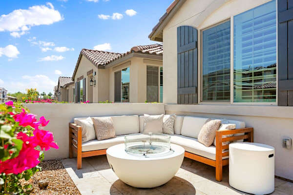 Relax on the patio with comfortable seating around a natural gas fire pit.