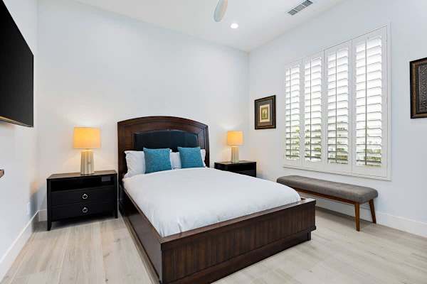 Second bedroom with plantation shutters and a peaceful retreat vibe for extra guests.