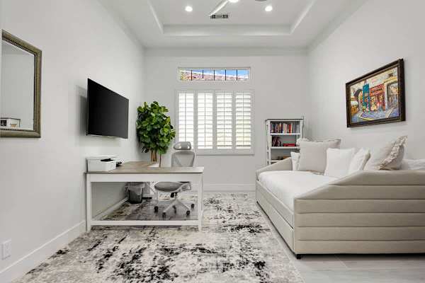 Fourth bedroom doubles as a home office with a daybed and workspace setup.
