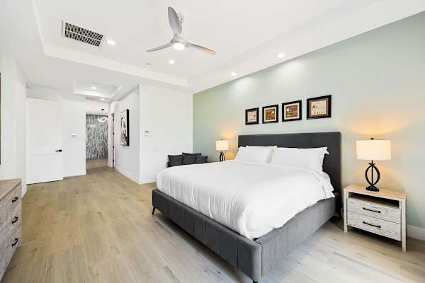 Spacious primary bedroom with direct access to the outdoor paradise.