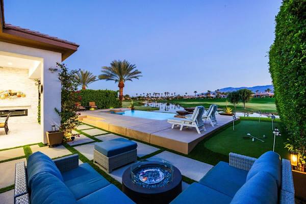 Cozy up around the fire pit with gorgeous sunset views over the mountains and golf course!
