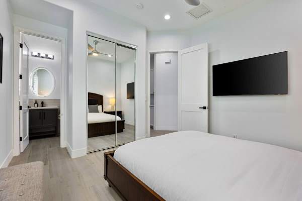 Guest bedroom with its own ensuite bathroom and flat-screen TV.
