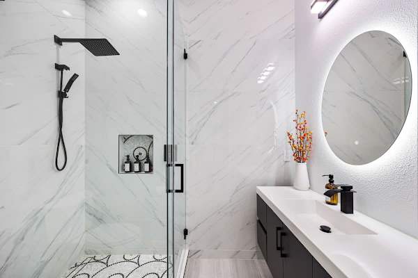 Elegant marble bathroom with a rainfall shower and modern touches.