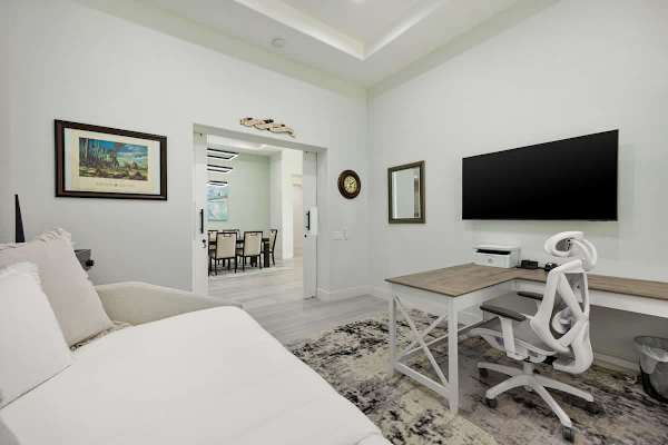 Flexible guest room with a comfortable daybed and large-screen TV.