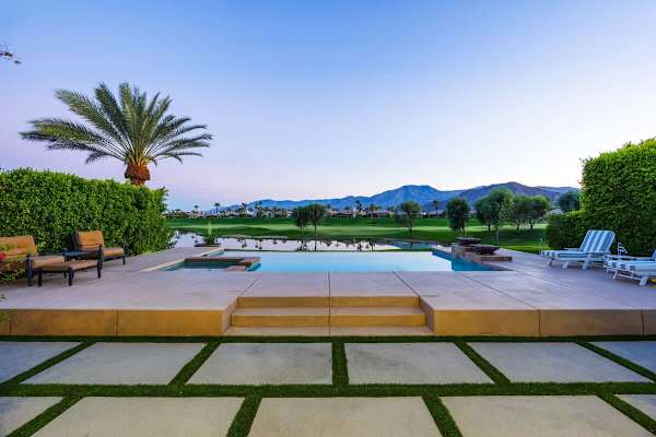 Evenings by the pool with panoramic mountain and fairway views. Pure desert luxury.