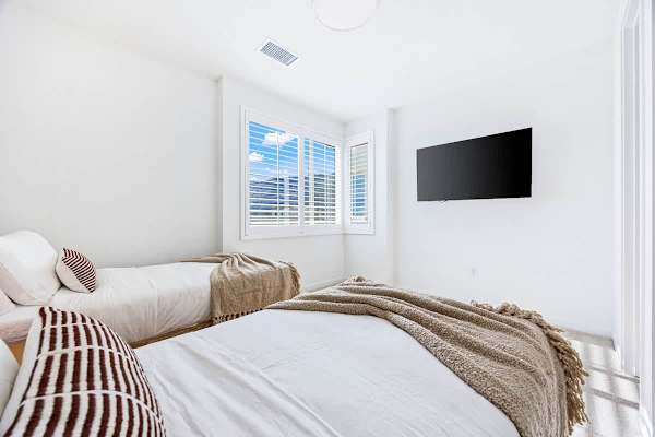 Crisp white linens and natural light in every bedroom here.