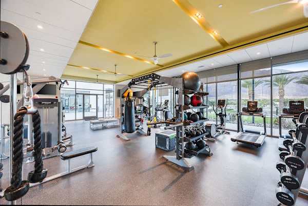 The community fitness center has cardio equipment and weights with mountain views.