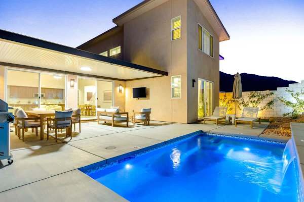 The house glows at sunset – pool nights are about to get good.
