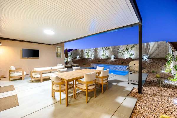 Dine outside under the stars with the pool glowing nearby.