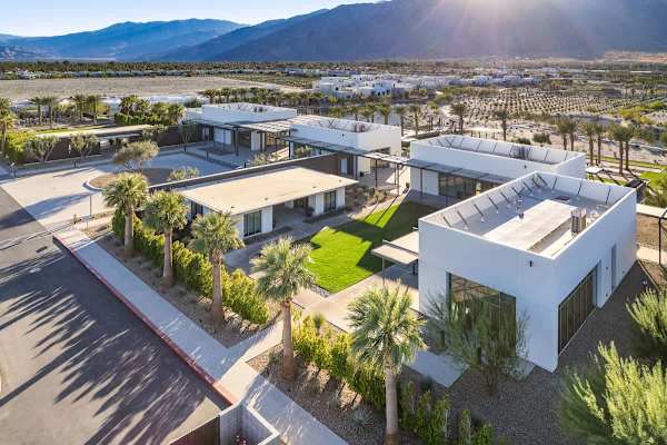 Aerial view of the modern clubhouse and landscaped grounds