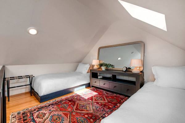 Master king bedroom, with ensuite bathroom and vaulted ceilings with a ladder up to an open loft with two additional twin beds.