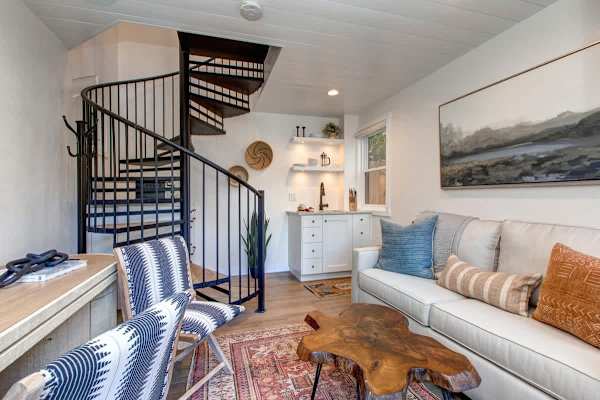 Detached guest suite accessed via the patio. Features a living area with a small kitchenette, TV, a desk and a queen sleeper sofa for additional guests.