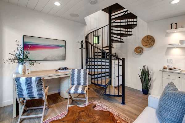 Detached guest suite accessed via the patio. Features a living area with a small kitchenette, TV, a desk and a queen sleeper sofa for additional guests.