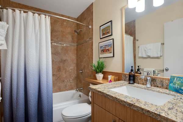 The first bathroom has a tub and a shower combination!