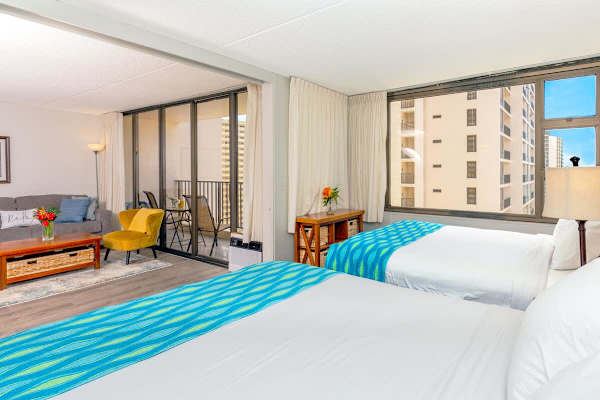 Bedroom with a view to your living room that has a nightstand light