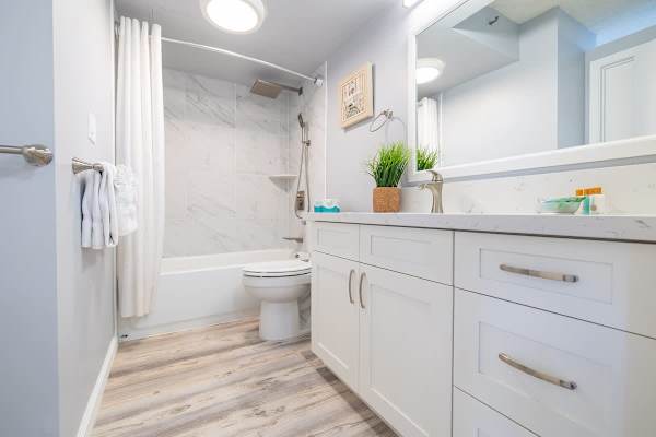 Renovated bathroom with bath tub and rainfall shower